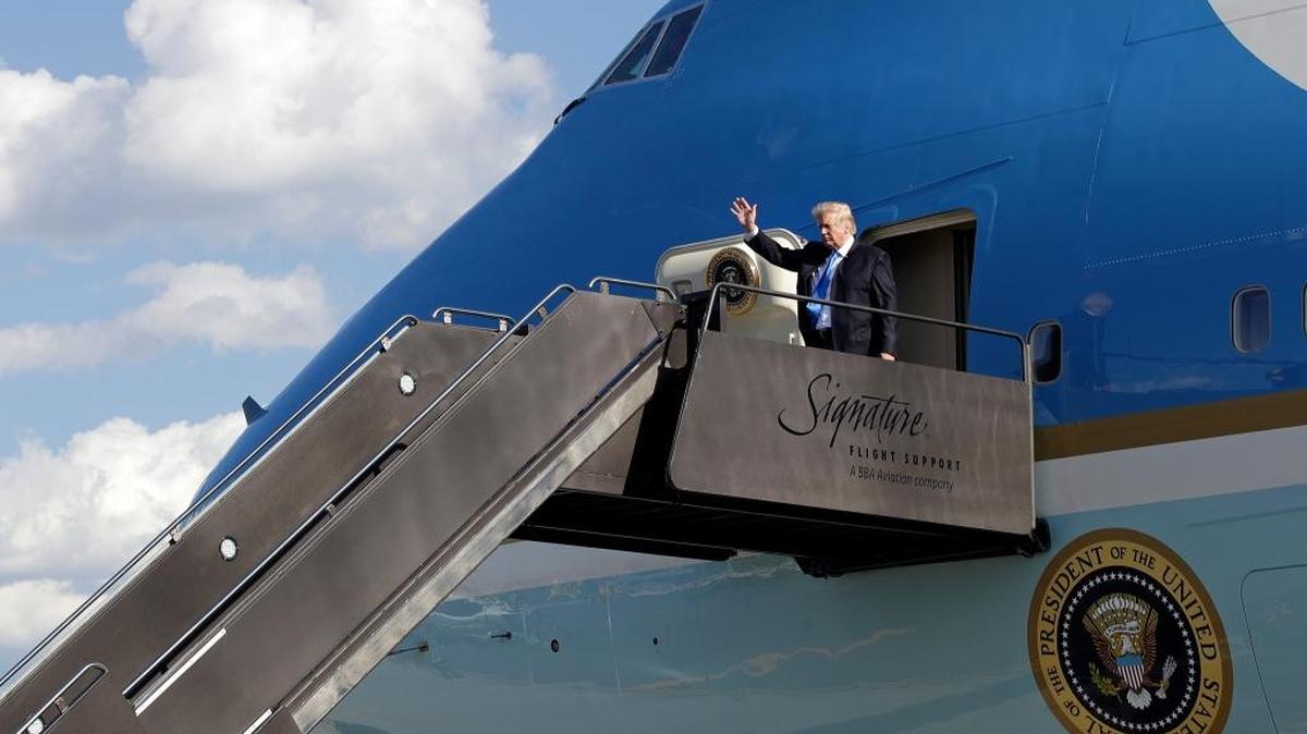 President Donald Trump waves as he steps off Air Force One as he arrives at Newark Liberty International Airport in Newark, N.J., Friday, June 9, 2017.