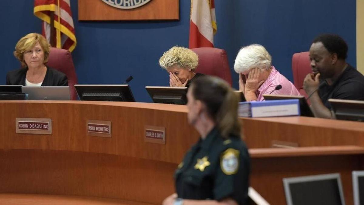 County Commission Chair Betsy Benac watches as commissioners Robin DiSabatino and Priscilla Whisenant Trace put their heads in hands Friday as Charles Smith addresses the room during a special meeting to discuss security ahead of the planned march and protests on Monday.