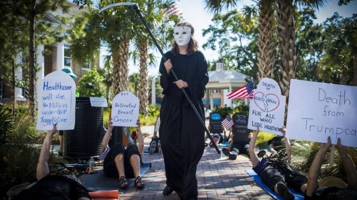 FILE PHOTO: Liv Coleman dresses as the grim reaper as activists gather for a “Die In” protest outside U.S. Rep. Vern Buchanan’s office May 11, 2017, in Bradenton. About two dozen people gathered to protest Buchanan’s vote to pass the Republican backed American Health Care Act out of the House of Representatives.