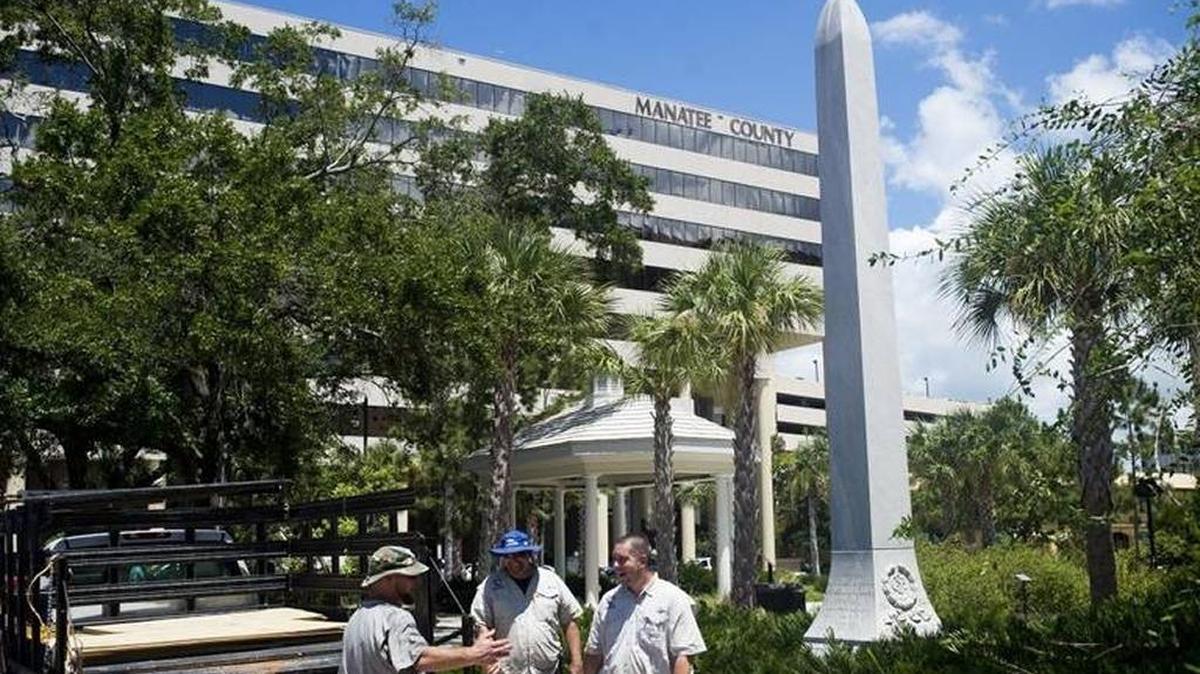 FILE: Workers prepare to cover the Confederate Monument outside of the Manatee County Historic Courthouse on Saturday afternoon in downtown Bradenton.