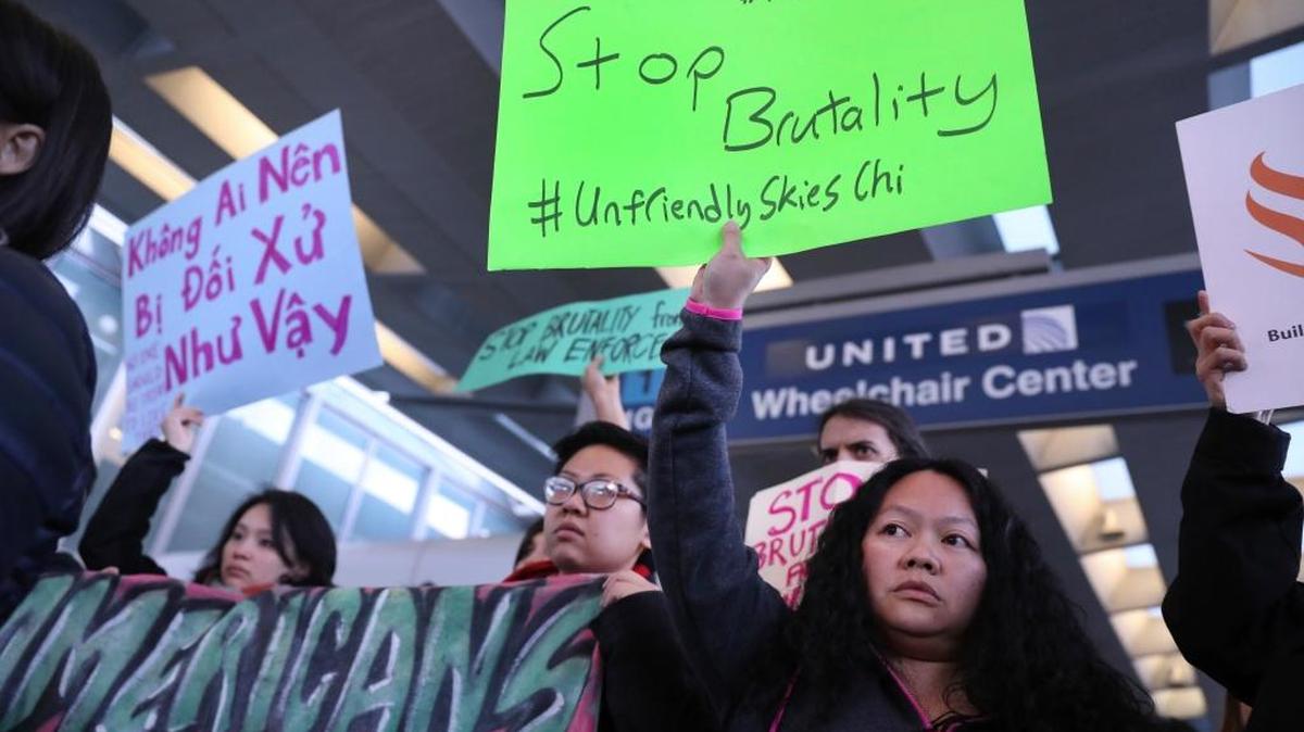 People with Asian community organizations from Chicago hold signs to protest after Sunday's confrontation where David Dao, 69, of Elizabethtown, Ky., was removed from a United Airlines airplane by Chicago airport police at O'Hare International Airport, during rally near United's counter at the airport's Terminal 1 in Chicago on Tuesday, April 11, 2017.