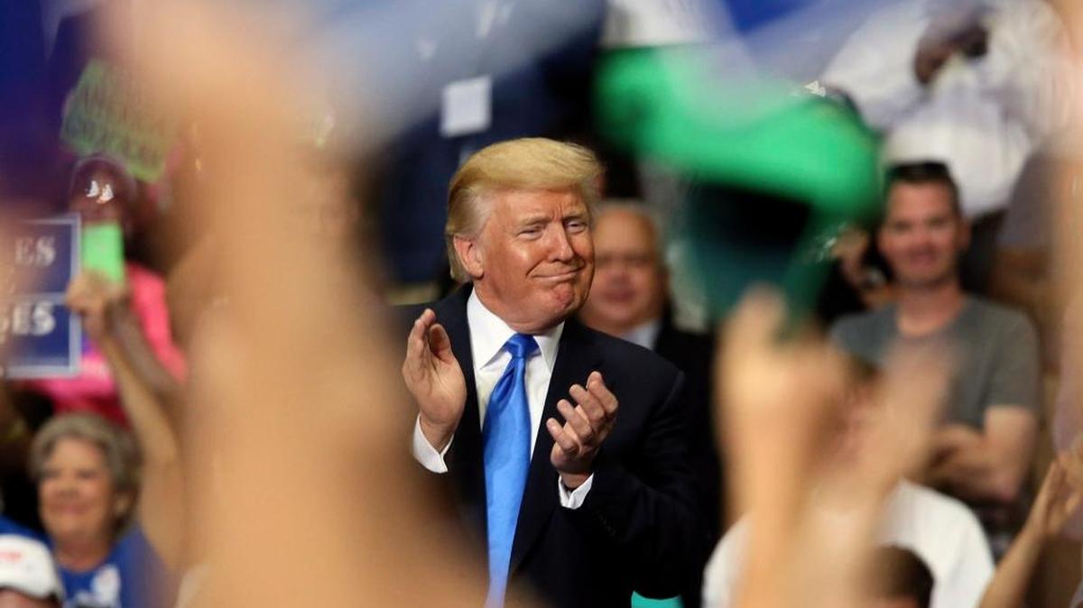 President Donald Trump joins in clapping as he basks in the applause at a Make America Great Again rally at the Covelli Centre in Youngstown, Ohio, on July 25, 2017.
