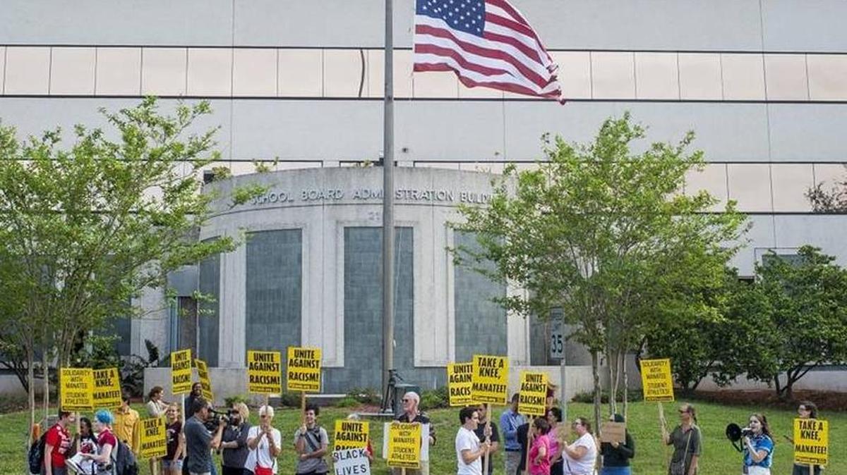 FILE PHOTO: The American flag flies as half mast as Manatee students, Answer Suncoast, Party for Socialism, Liberation and the NAACP and others rally Oct. 3 outside the Manatee County School Board building in downtown Bradenton.