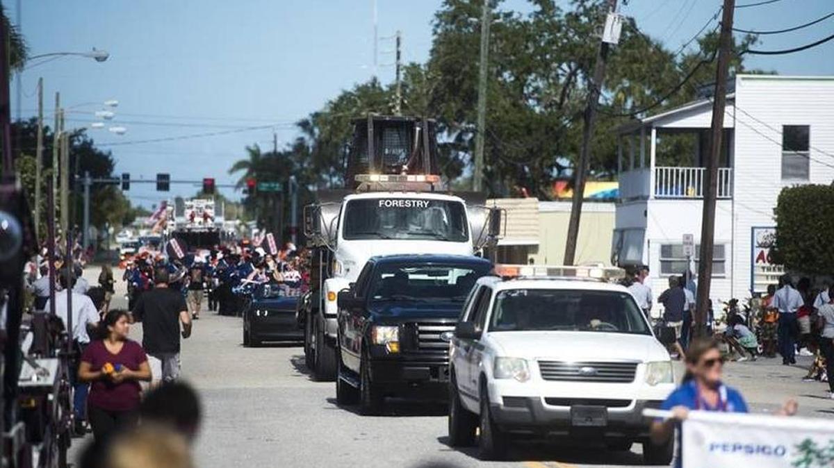 FILE: Trucks drive down the spectator-lined road during the annual Palmetto Veterans Parade Nov. 11 in Sutton Park in Palmetto.