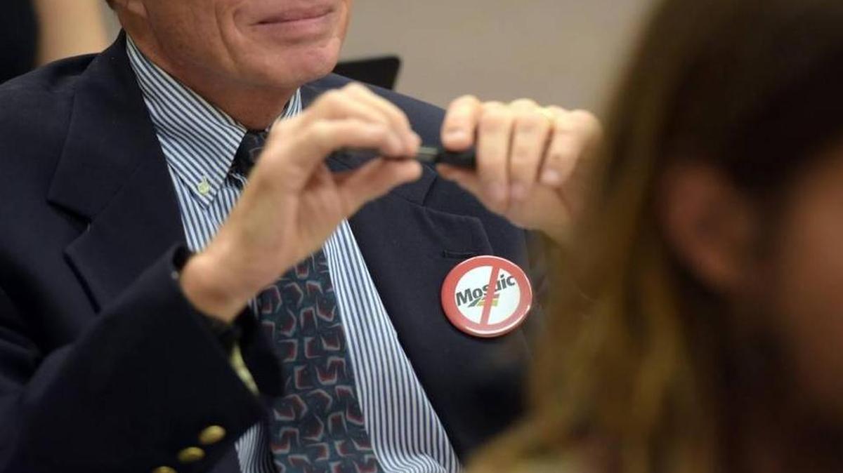 FILE: An anti-mosaic pin adorns a man's suit during the Manatee County Commission's public hearing Jan. 26 on Mosaic's proposal to expand mining operations in East Manatee.