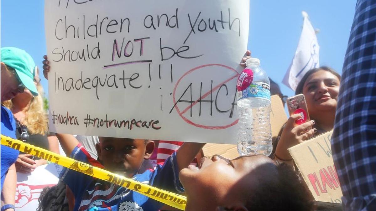 Aubrey Pratt, 5, at a rally with U.S. Sen. Kamala Harris, D-Calif., with doctors, nurses, health care workers and patients at a rally against the GOP health care bill Monday in Torrance, Calif.