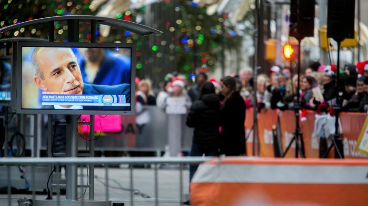 Fans of the "Today" show watch a live broadcast outside of the studio in New York, Nov. 30, 2017, about sexual misconduct allegations against Matt Lauer, who, for some, has been a part of their morning ritual for decades.