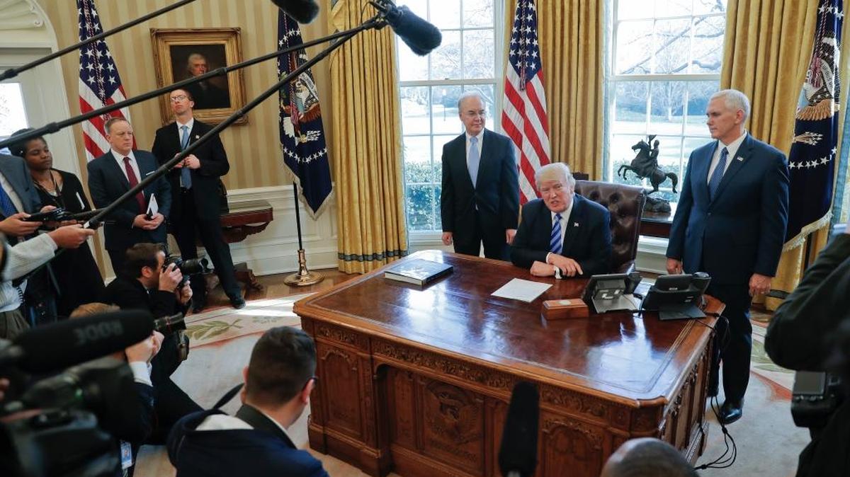 President Donald Trump, flanked by Health and Human Services Secretary Tom Price, left, and Vice President Mike Pence, right, addressing members of the media regarding the health care overhaul bill, Friday, March 24, 2017, in the Oval Office of the White House in Washington.