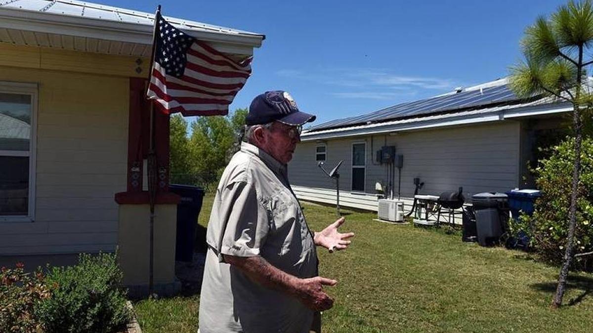 FILE PHOTO: Terrill Symons talks about the solar panels on the roof of his Habitat for Humanity home. Manatee County Habitat for Humanity is focused on making sustainable home building and repairs.