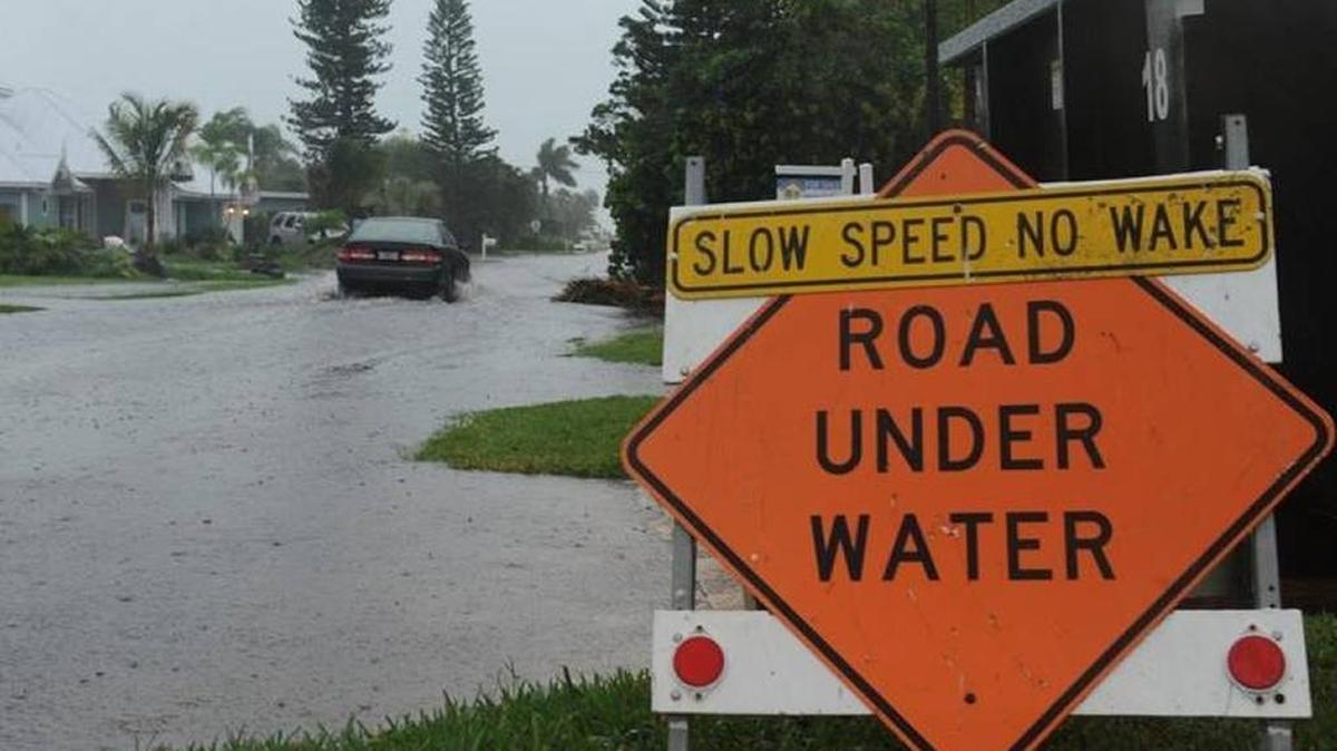FILE: A car moved slowly through a flooded street in Holmes Beach as Tropical Storm Andrea moved over Anna Maria Island in 2013.
