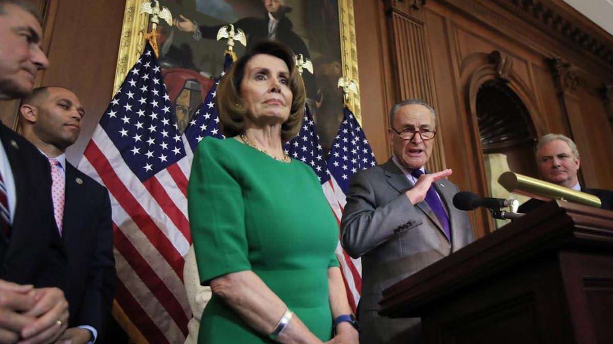 Senate Minority Leader Charles Schumer of N.Y., with, from left, Rep. John Yarmuth, D-Ky.; Rep. Hakeem Jeffries, D-N.Y.; House Minority Leader Nancy Pelosi of Calif. and Sen. Chris Van Hollen, D-Md., speaks to reporters about President Donald Trump's first 100 days, during a news conference on Capitol Hill in Washington, Friday, April 28, 2017.
