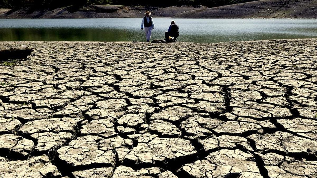 FILE - This March 13, 2014 file photo shows cracks in the dry bed of the Stevens Creek Reservoir in Cupertino, Calif.