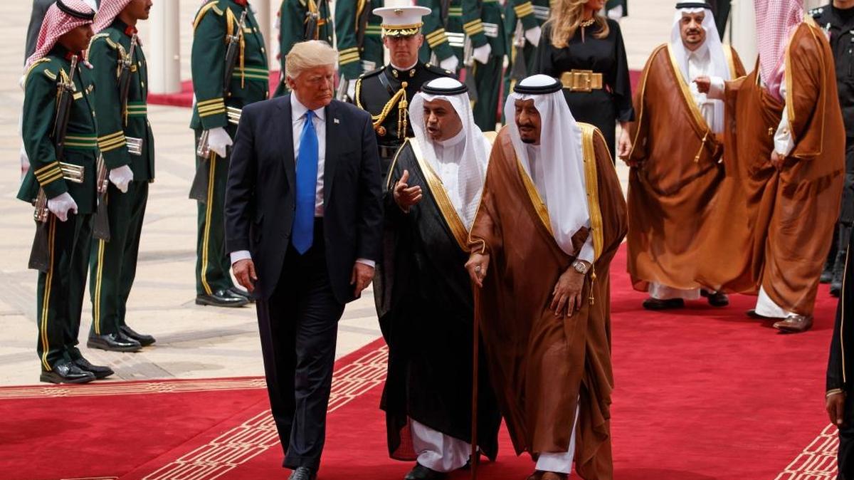 President Donald Trump walks with Saudi King Salman during a welcome ceremony at the Royal Terminal of King Khalid International Airport, Saturday, May 20, 2017, in Riyadh.
