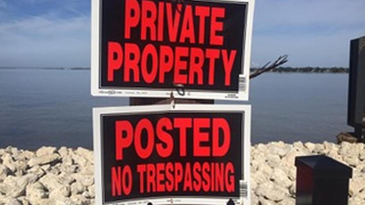 Signs posted when the Point Pleasant Point fence was installed