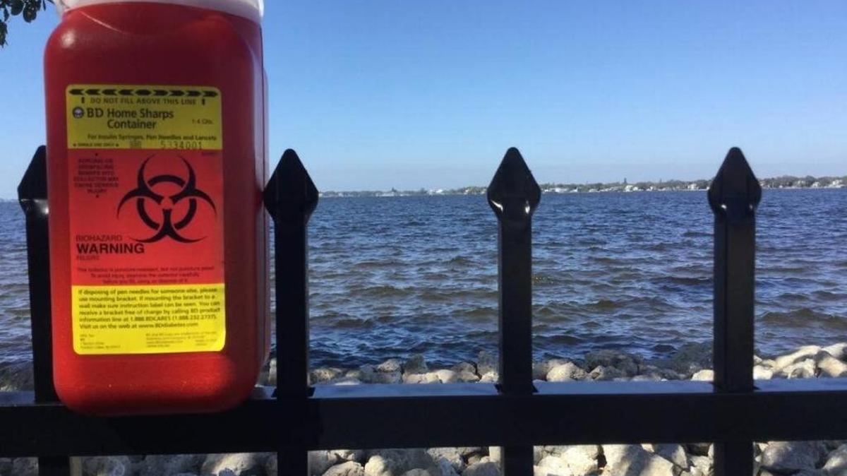 Point Pleasant resident Ryan Snyder contends there are 100 syringes in this container from along his property.