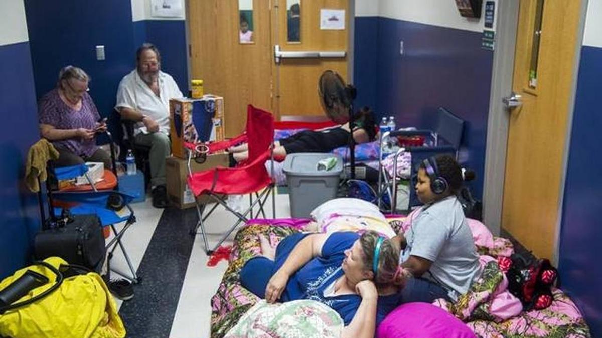 FILE: Evacuees rest in makeshift camps in the hallway of Bayshore Elementary School as Hurricane Irma approaches South Florida on Sunday morning in Bradenton.