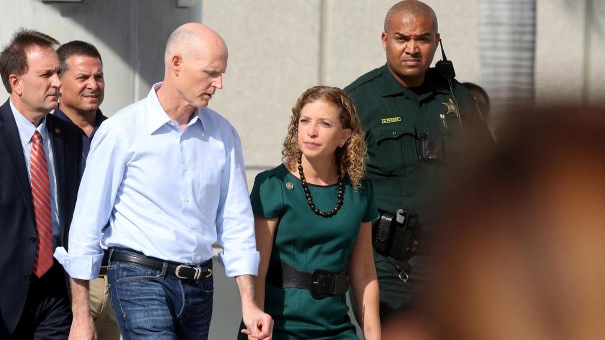 Governor Rick Scott and Rep. Debbie Wasserman Schultz get ready to speak to the media after Fort Lauderdale International Airport reopened on Saturday, Jan. 7, 2017, a day after a shooting in the baggage area of Terminal 2.