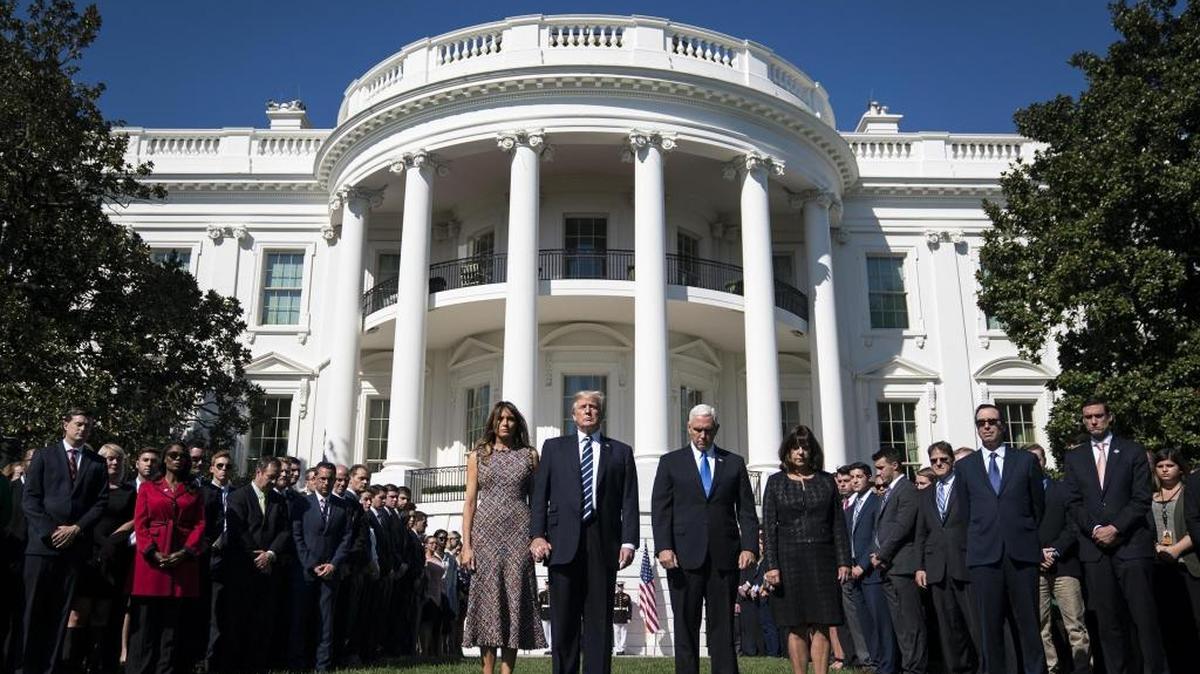 President Donald Trump and first lady Melania Trump stand with Vice President Mike Pence, his wife Karen, and members of the White House on the South Lawn at the White House on Monday.