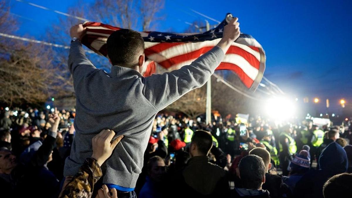 In this 2016 file photo, a Donald Trump supporter waves a U.S. flag as he and others face off with anti-Trump protesters in Bethpage, N.Y.