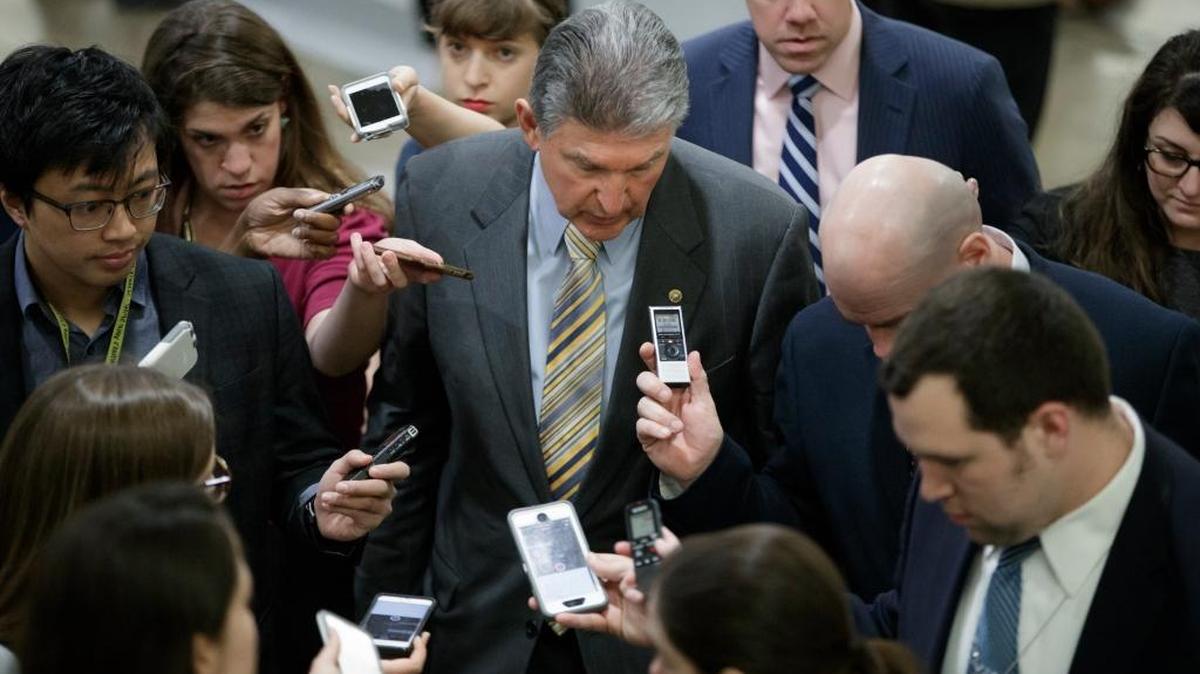 With questions on the Syria airstrikes and the Supreme Court, Sen. Joe Manchin, D-W. Va., speaks to reporters on the way to the confirmation vote for President Donald Trump's high court nominee, Neil Gorsuch, on Capitol Hill in Washington, Friday, April 7, 2017. Manchin is one of three moderate Democrats up for re-election in states Trump won last fall who voted with the Republicans.