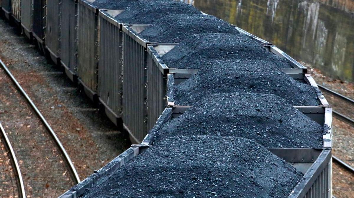 In this Jan. 26, 2017, photo, a Norfolk Southern freight train hauling coal makes its way through downtown Pittsburgh. President Donald Trump's decision to withdraw the United States from the Paris climate accord may have only limited immediate impact on many U.S. companies, according to analysts.