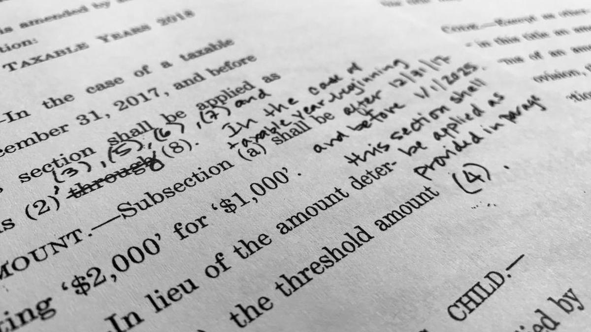 Part of the Republican Senate bill "Tax Cuts and Jobs Act" with handwritten notes outlining changes is photographed in Washington. Republican tax legislation advancing toward final votes in Congress could undermine Obamacare health insurance markets, and add to the financial squeeze on Medicare over time.