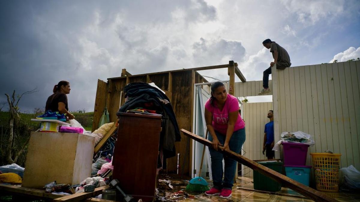 People try to recover their belongings to start rebuilding their house that was destroyed by Hurricane Maria, in Morovis, Puerto Rico.