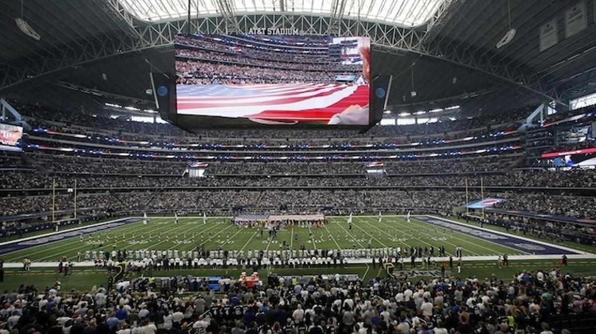 Teams and fans stand during the playing of the national anthem in this general, overall, view, of AT&T Stadium before an NFL football game between the Los Angeles Rams and Dallas Cowboys on Oct. 1, 2017, in Arlington, Texas.