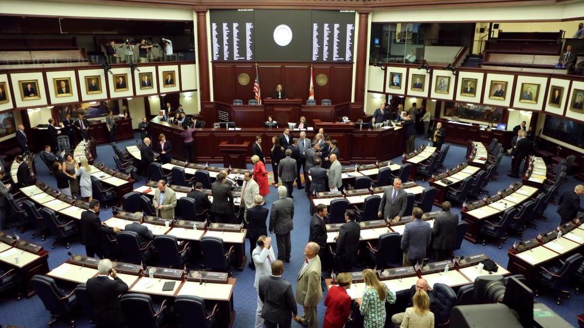 FILE PHOTO: Florida representatives greet each other on the house floor in 2015, in Tallahassee.