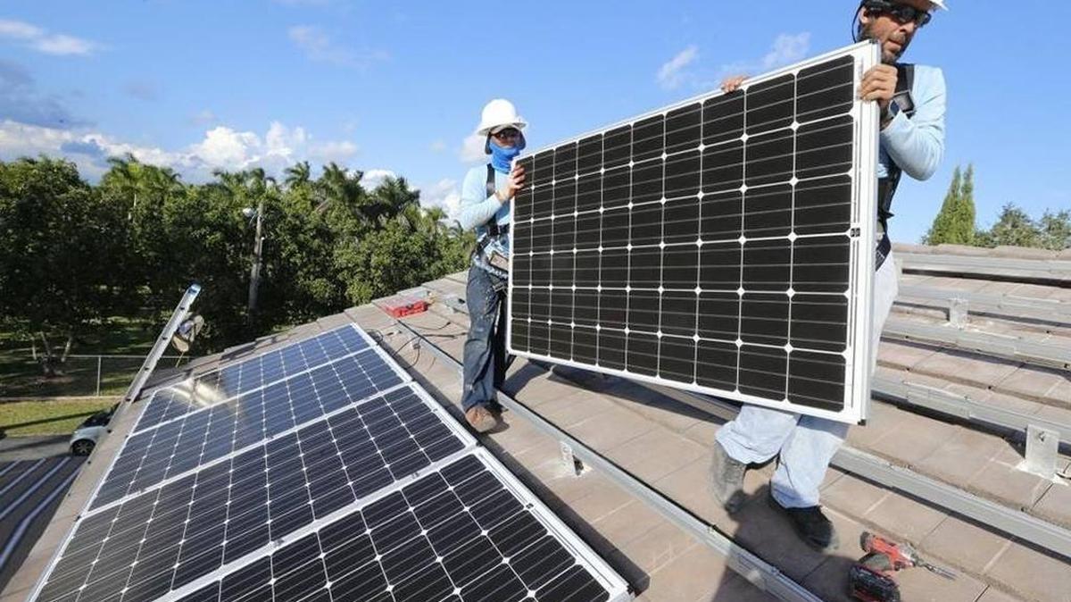 Workers with Cutler Bay Solar Solutions install solar panels in 2015 at a home in South Miami-Dade.