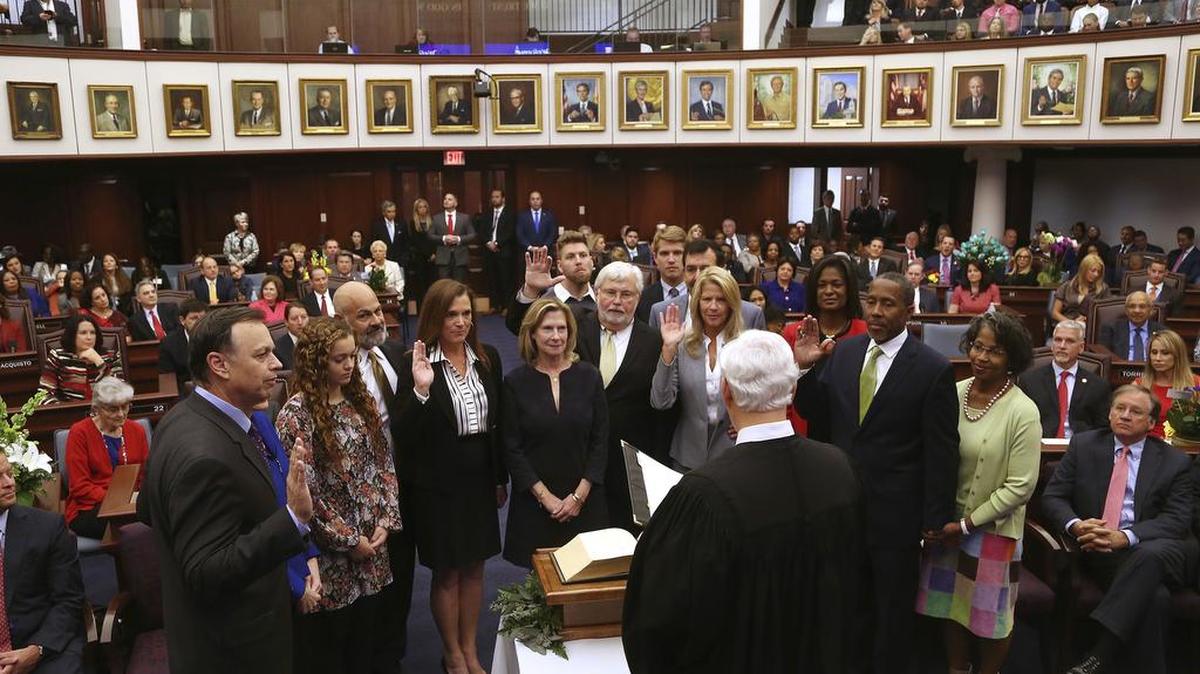 Senators are sworn in by Florida Supreme Court Justice Ricky Polston, Tuesday, Nov. 22, 2016, at the Florida House, in Tallahassee, Fla. From left standing with their family members are Senators Tom Lee, Victor Torres, Dana Young, Jack Latvala, Debbie Mayfield, and Darryl Rouson.