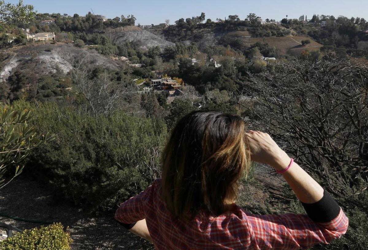 Wendy Schwartz stands in her back yard of her Bel-Air neighborhood homein Los Angeles, on Dec. 13, 2017. The fire recent fire burned in the canyon behind her home, and burned homes across the street from her property.