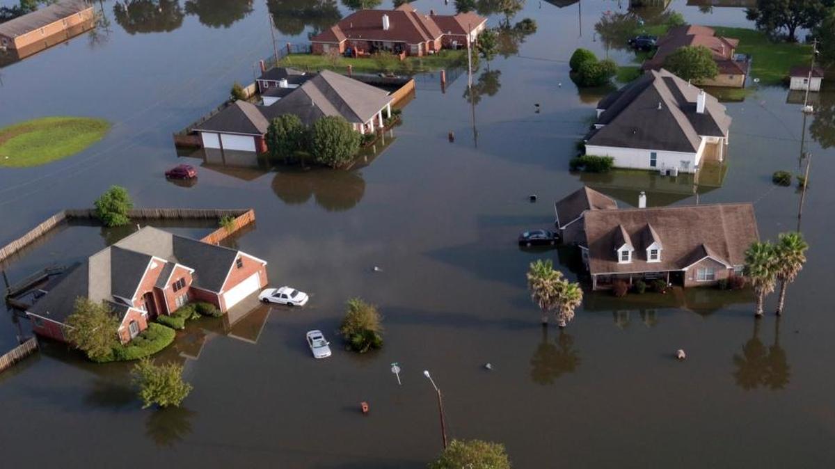 In this aerial photo, homes sit Friday in floodwaters caused by Tropical Storm Harvey in Port Arthur, Texas. Port Arthur's major roads were swamped by rising waters brought by Harvey.