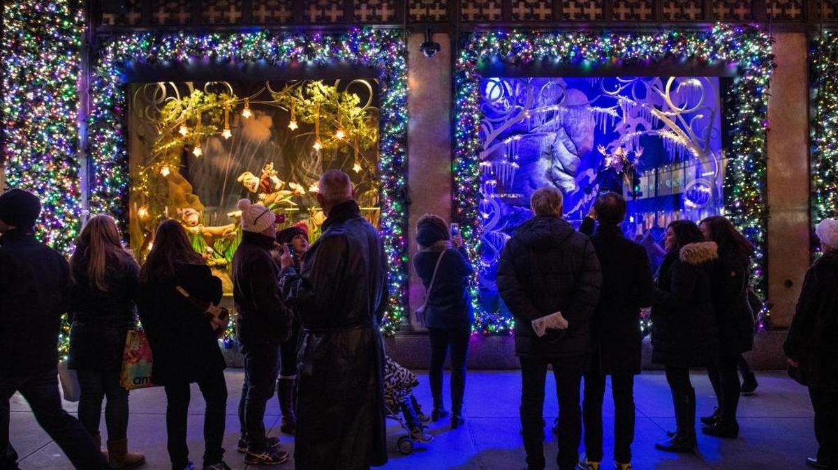 Passersby and tourists outside the holiday window displays at Saks Fifth Avenue in New York.
