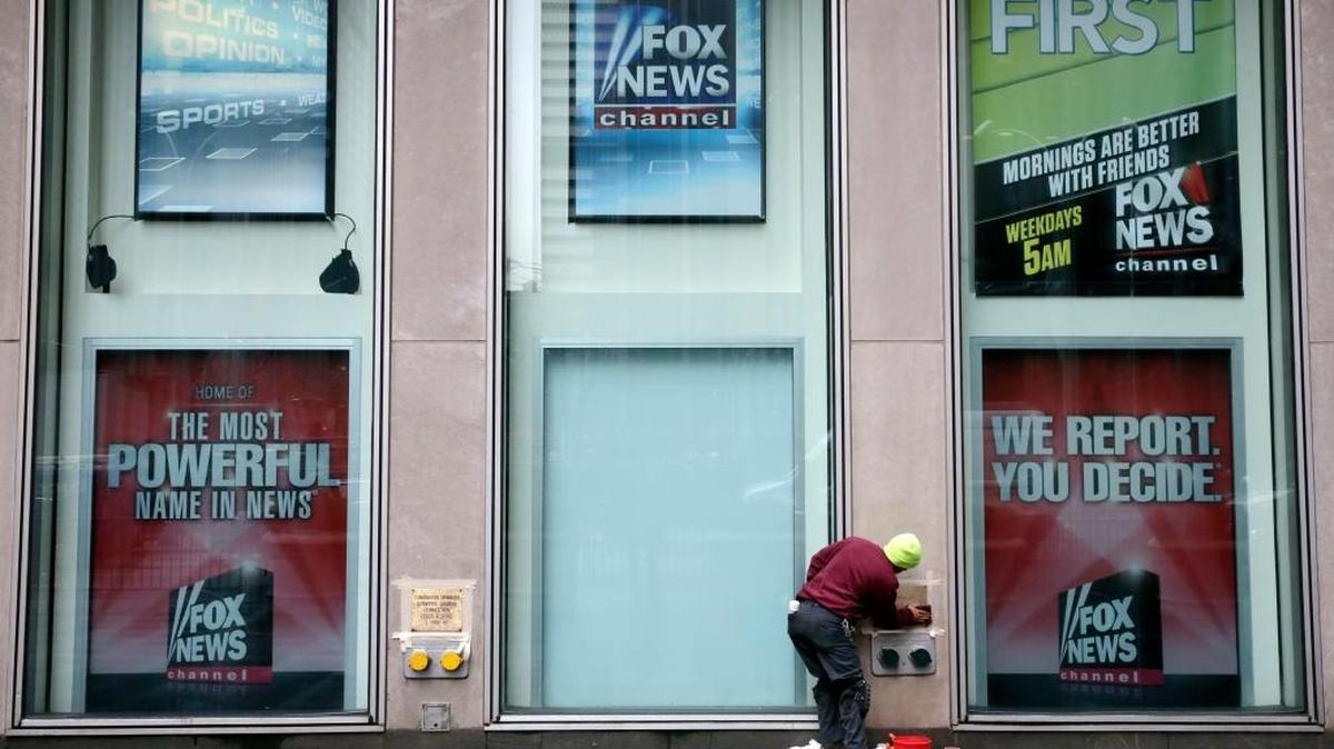 A worker cleans a sign outside the Fox television studios, where a poster of Bill O'Reilly has been removed, in New York, Thursday morning, April 20, 2017. Despite the inglorious end to O'Reilly's two-decade Fox News Channel career, observers say his deep imprint on Fox and other cable news outlets and his influence on barbed political discourse are intact for the foreseeable future.