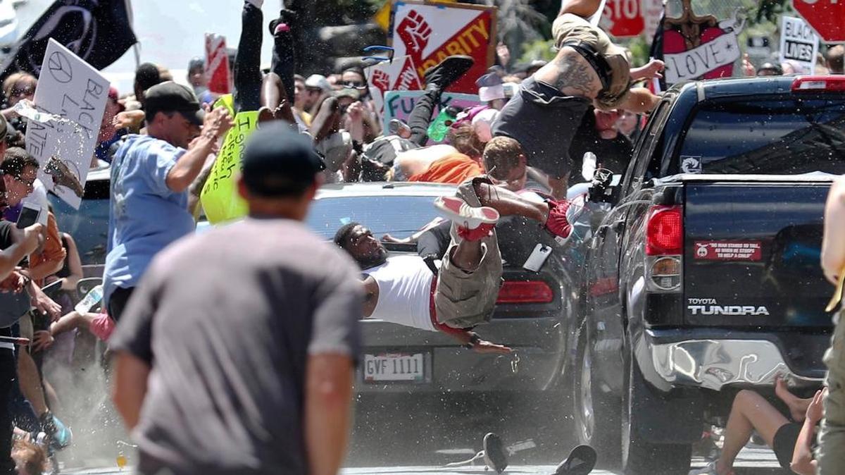 People fly into the air as a vehicle drives into a group of protesters demonstrating against a white nationalist rally in Charlottesville, Va., Saturday, Aug. 12, 2017.