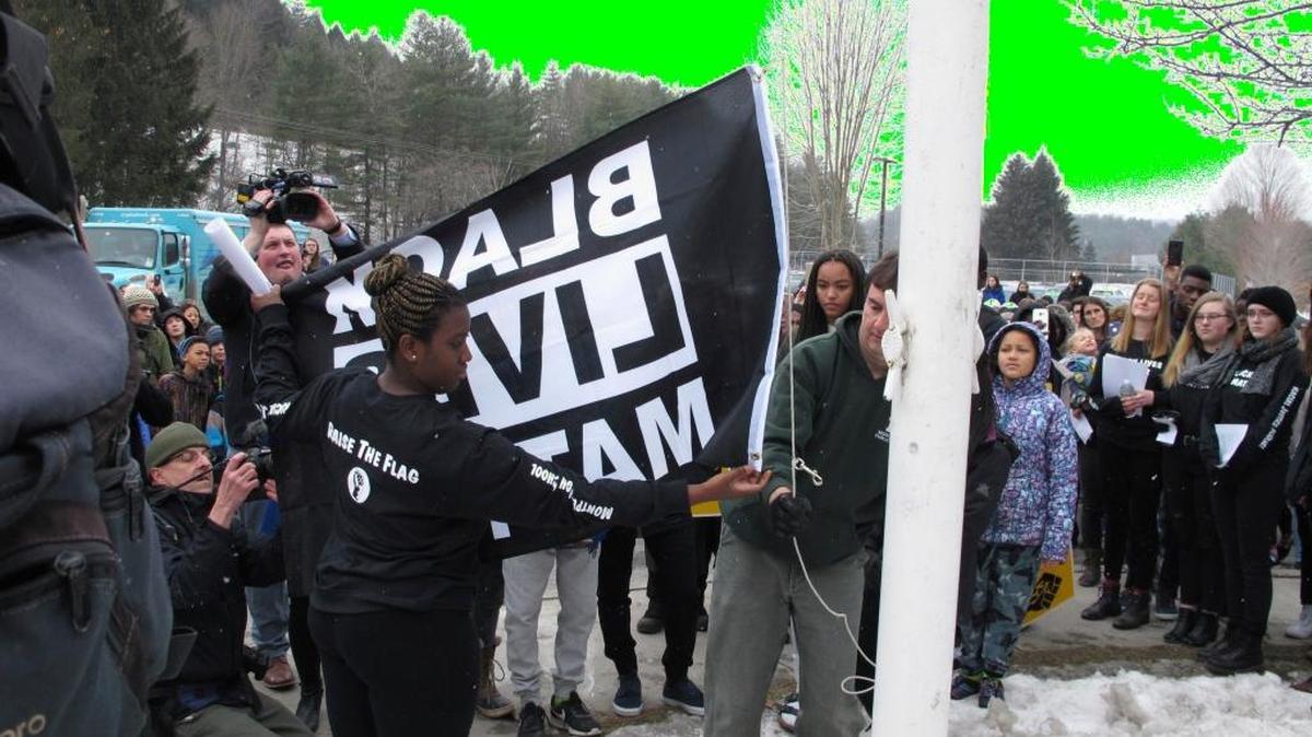 Students at the Montpelier High School in Montpelier, Vt., raise a Black Lives Matter flag on Thursday, Feb. 1, 2018, as part of a series of activities on racism. The student-led move, part of Black History Month, in the Montpelier school that is less than 5 percent black has sparked some backlash, but school officials say they've received overwhelming support from the community. On Thursday, black students took turns raising the flag in a ceremony attended by students, staff and community members.