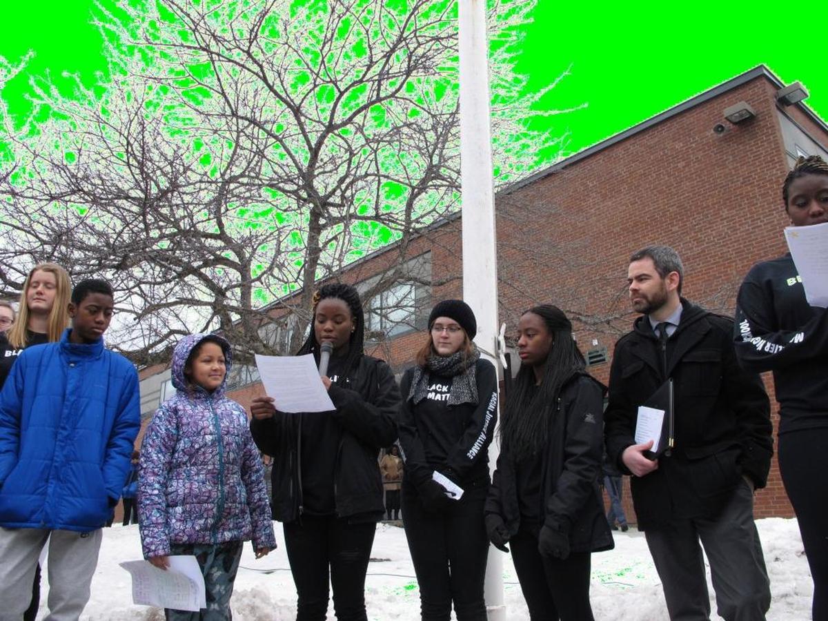 Students at the Montpelier High School in Montpelier, Vt., took turns raising the flag in a ceremony attended by students, staff and community members. (AP Photo/Lisa Rathke)