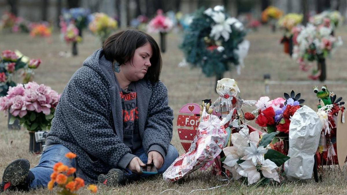 Amy Pittman visits the grave of her son, Christian, in Durham, N.C., on Feb. 10, 2017. Pittman was charged in 2014 with manslaughter after 9-year-old Christian was accidentally shot and killed by his older brother. A kid dies from an accidental shooting every other day in the United States, according to collaborative investigative report published last fall by the Associated Press and USA Today.