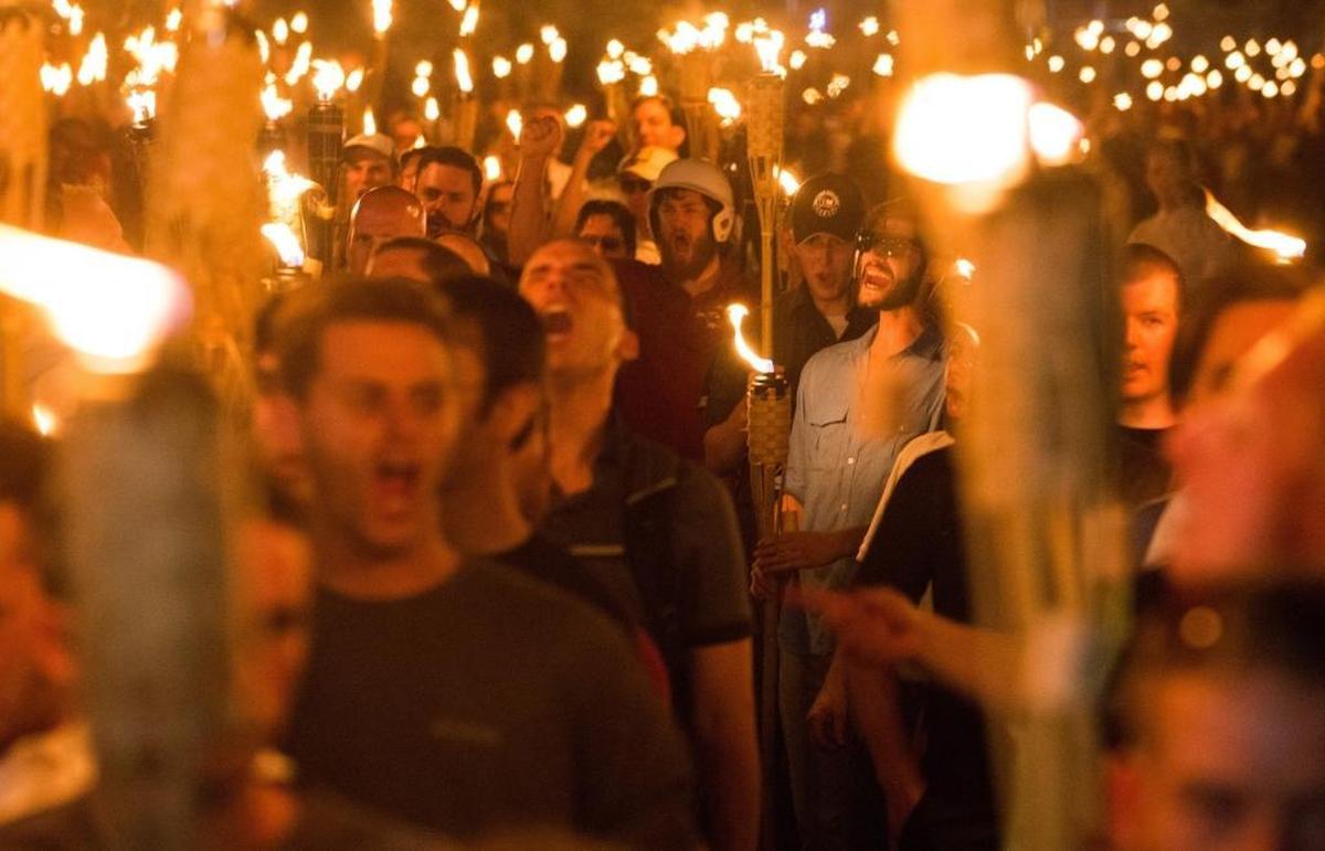 Neo-Nazis, alt-right and white supremacists march the night before the ‘Unite the Right’ rally, on Friday, Aug. 11, 2017, through the University of Virginia in Charlottesville, Va.