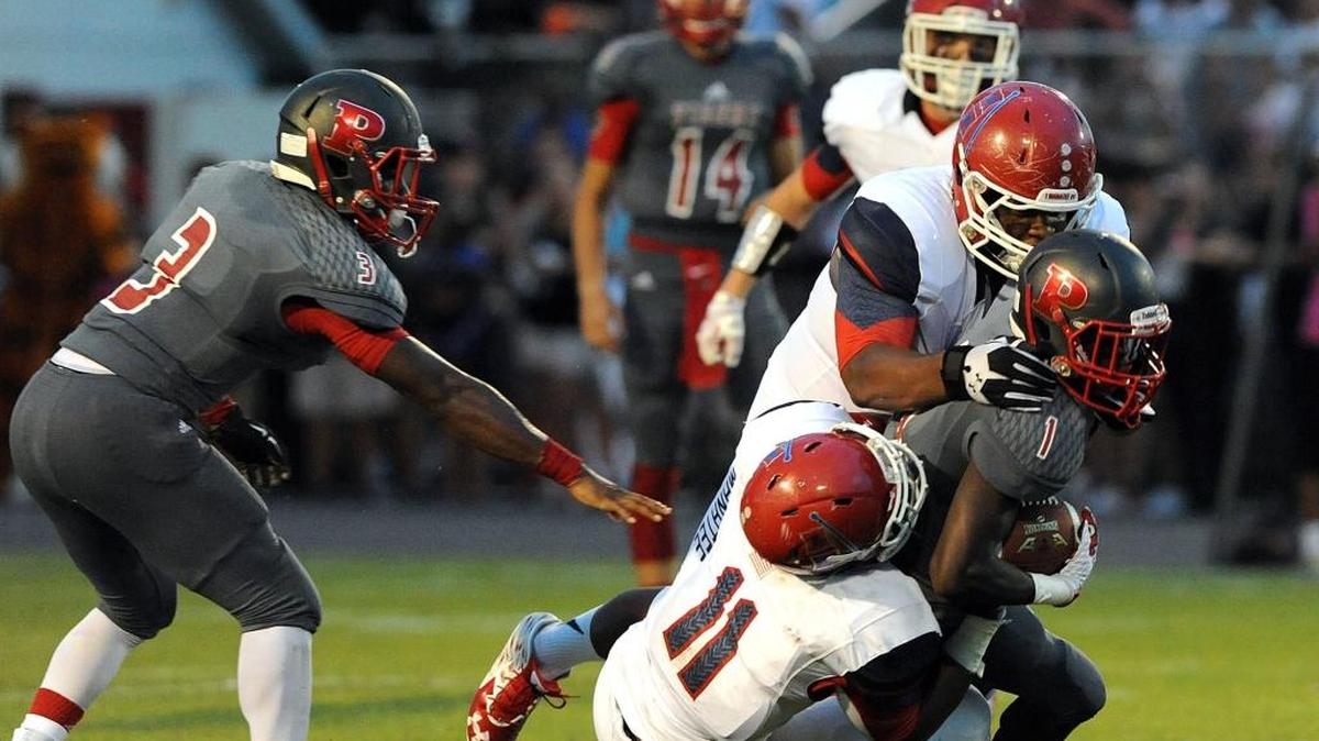 Palmetto’s Azavion Smith is caught by Manatee’s defense during last year’s rivalry game at Harlee Stadium.