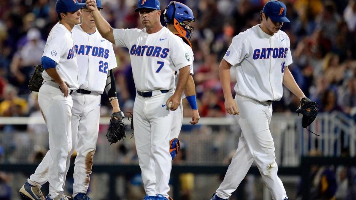 Florida pitcher Tyler Dyson, right, walks off the field after being replaced during the seventh inning against LSU in Game 2 of the NCAA College World Series baseball finals in Omaha, Neb., on Tuesday.