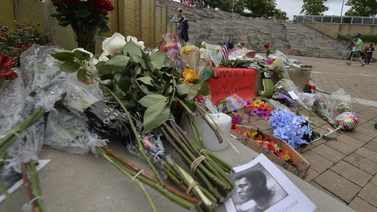 Flowers and mementos lay at a memorial for Muhammad Ali at the Muhammad Ali Center Saturday in Louisville Ky. Ali will be buried Friday in his hometown after a public memorial and processional through the streets.