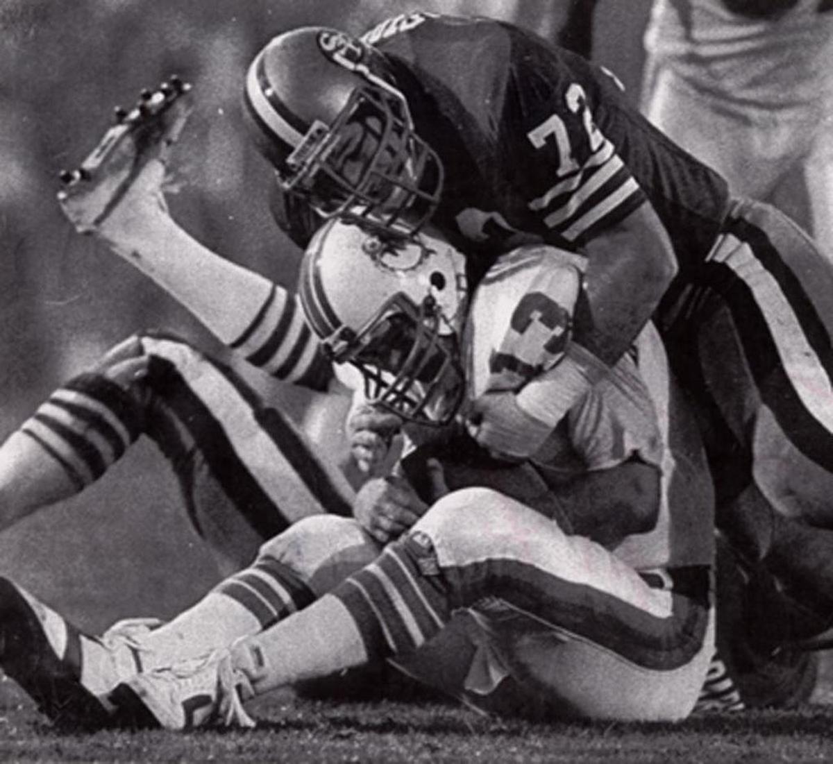 Dolphins QB Dan Marino is doubled over as he’s sacked by San Francisco’s Jeff Stover, one of four sacks Marino took in the Dolphins 38-16 Super Bowl XIX loss to the 49ers Stanford Stadium.