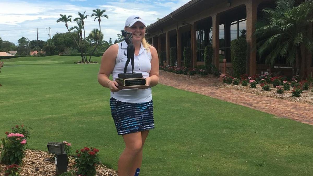Lake Mary’s Roanne Tomlinson poses with her trophy after winning the Florida State Golf Association Women’s Amateur Stroke Play Championship on Sunday at Sara Bay Country Club in Sarasota.