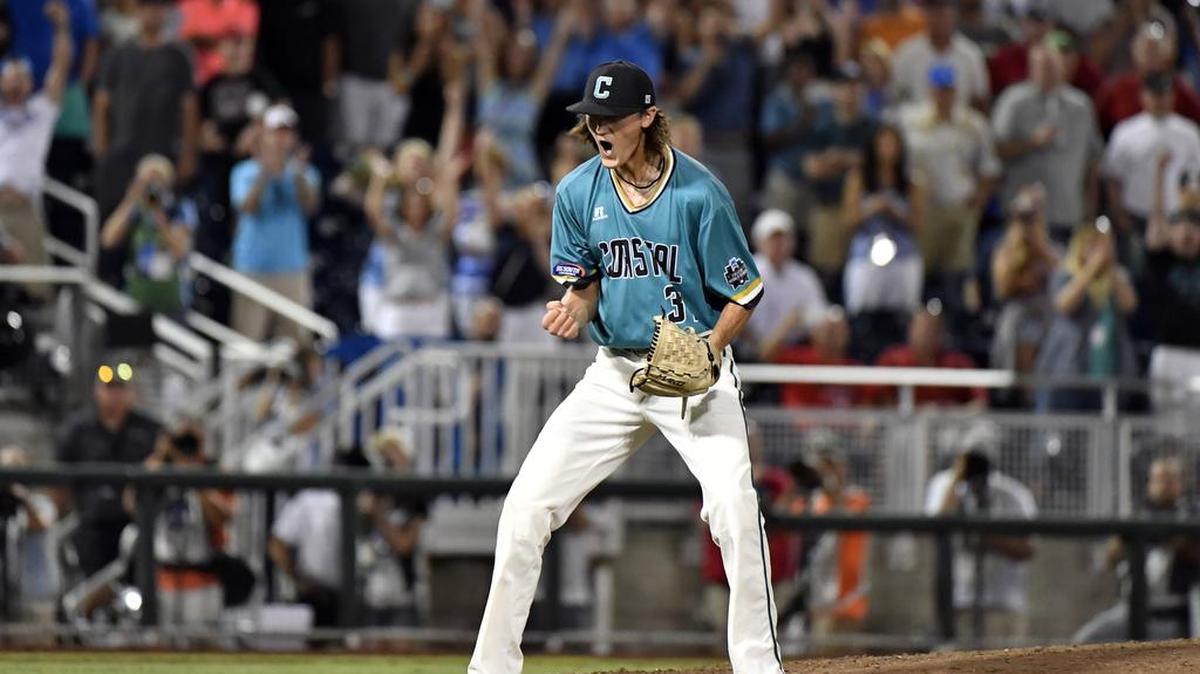 Coastal Carolina pitcher Bobby Holmes celebrates after getting the final out against Arizona in the ninth inning in Game 2 of the NCAA Men’s College World Series finals baseball game in Omaha, Neb., Tuesday. Coastal Carolina won 5-4.