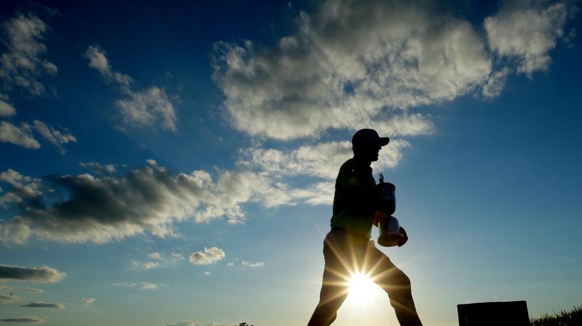Brooks Koepka walks away with the winning trophy after the U.S. Open on Sunday at Erin Hills in Erin, Wis.