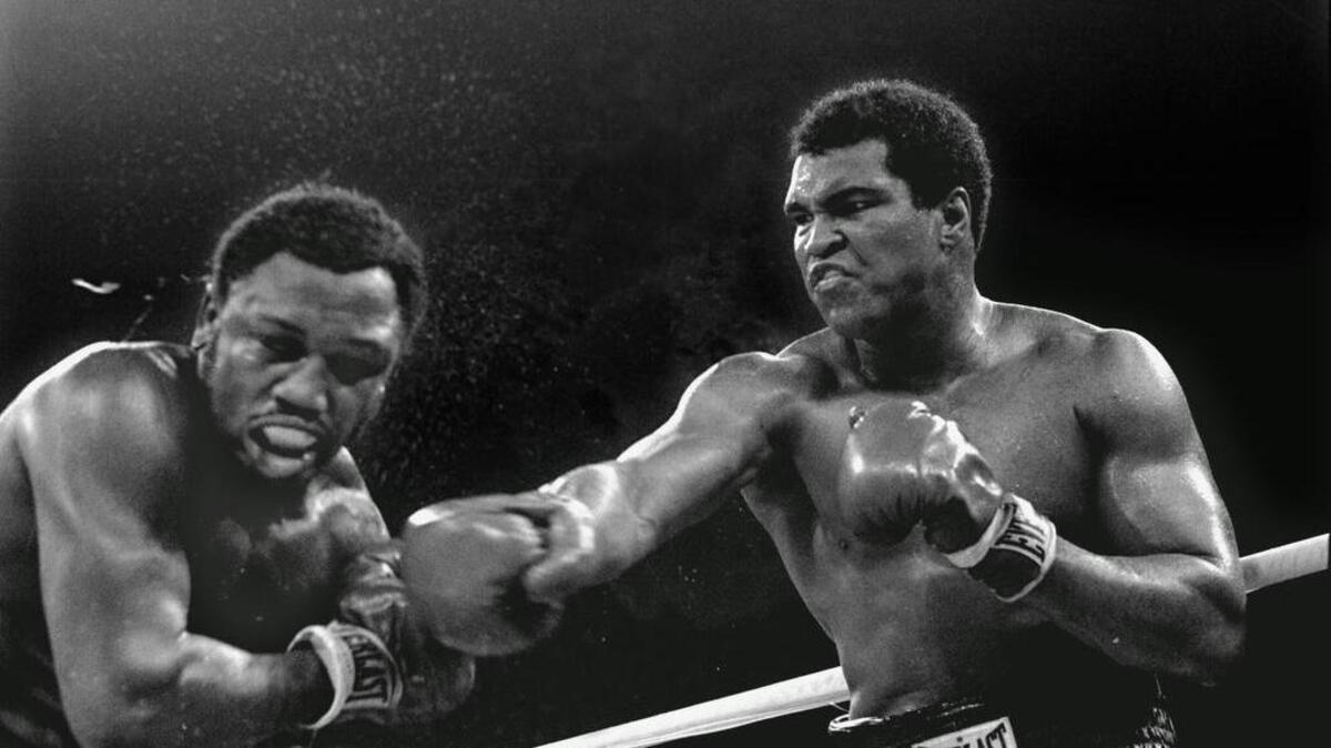 In this Oct. 1, 1975 file photo, heavyweight champion Muhammad Ali connects with a right against challenger Joe Frazier in the ninth round of their title fight in Manila, Philippines. Ali won the fight on a decision to retain the title.