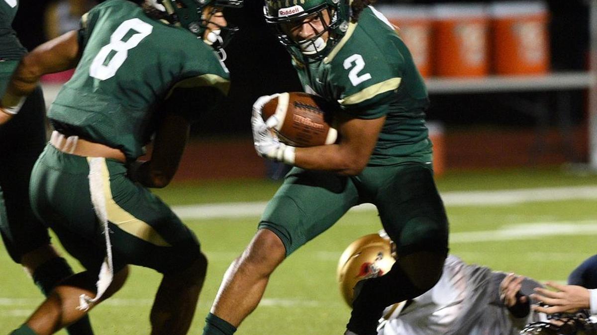Saint Stephen's Chase Brown dodges Bishop McLaughlin defenders during Friday night's game at Turner Field in Bradenton.
