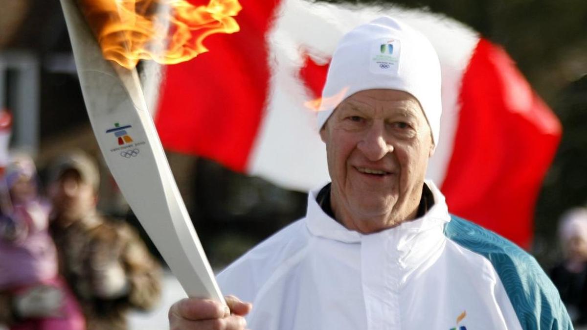 Hall of Fame hockey great Gordie Howe carries the Olympic flame in LaSalle, Ontario, on Dec. 23, 2009 during the 2010 Vancouver Olympics torch relay.